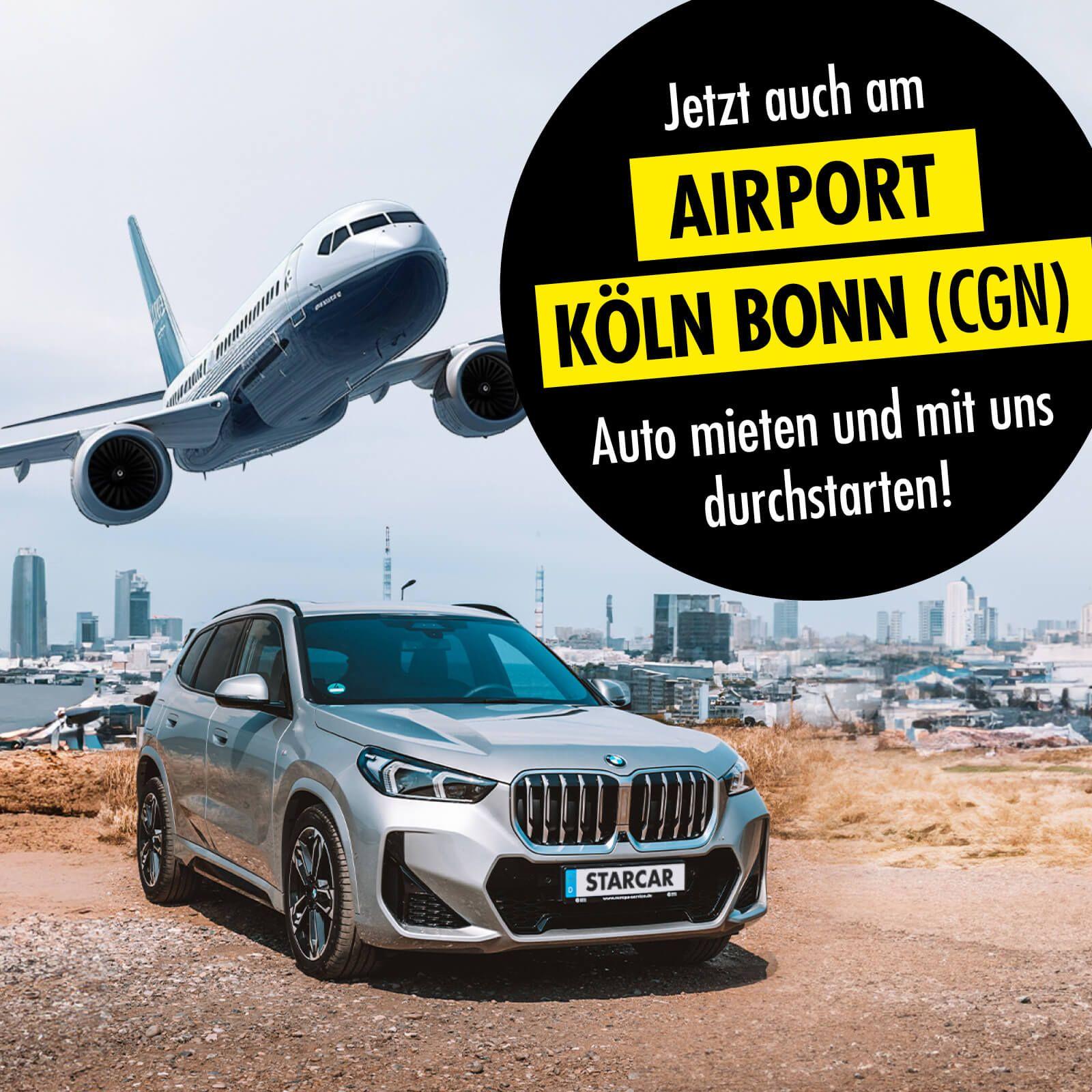 Silbernes BMW SUV geparkt in der Nähe eines Flughafens mit Stadtkulisse.